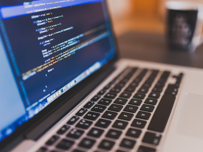 Up-close shot of a laptop with code on the screen 